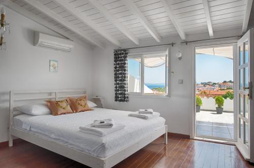 a bedroom with a bed with a view of the ocean at Amaranda Ada Evi in Bozcaada