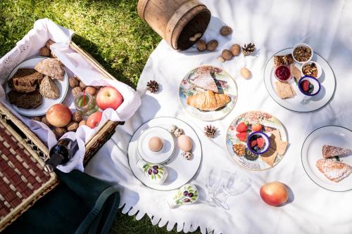 a picnic table with plates of food on it at Hotel Tann in Collalbo