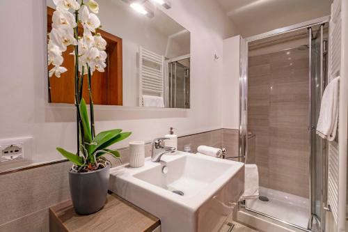 a white bathroom with a sink and a shower at central apt in Venice