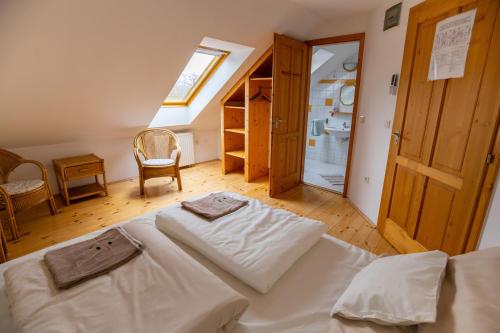 a large bed in a room with a window at NOBLE'S Panzió és Étterem in Nemesnép