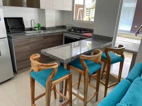 a kitchen with a table and chairs and a counter at Casa de Playa frente al mar. in Coveñas