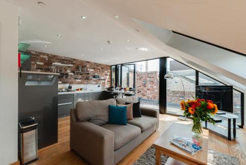 a living room with a couch and a table at Base Serviced Apartments - Sir Thomas Street in Liverpool