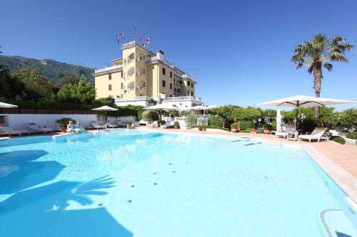 a large swimming pool in front of a building at La Medusa Hotel - Dimora di Charme in Castellammare di Stabia