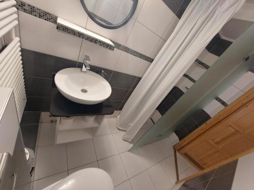 a bathroom with a white toilet and a sink at Palma Vendégház in Szeged