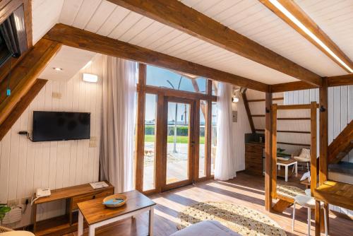 a living room with a tv on the wall at Matarma Beach Residence in Ras Sedr