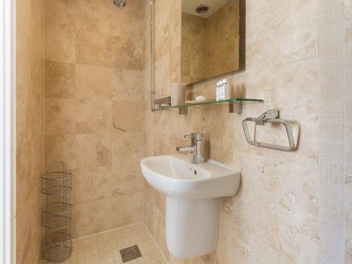 a bathroom with a sink and a mirror at Alfred Wallis in St Ives