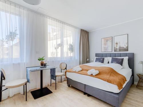 a bedroom with a large bed and a desk at Limehome Klagenfurt Karfreitstraße in Klagenfurt