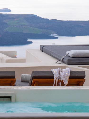 a view of the ocean from the roof of a boat at Caldera Cliff Illusion in Fira