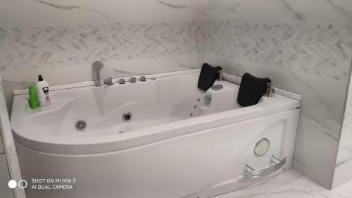 a white bath tub in a white bathroom at White House in Bălţi