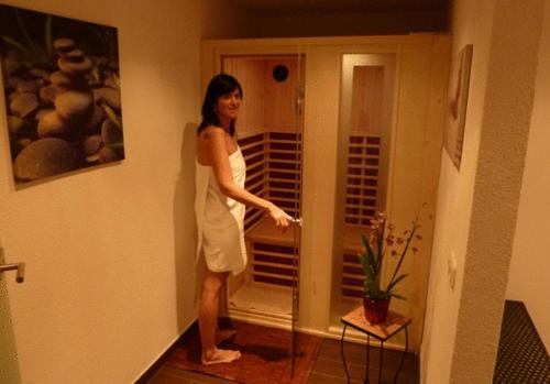 a woman in a white dress standing in a hallway at Pension Mühle in Zell am See