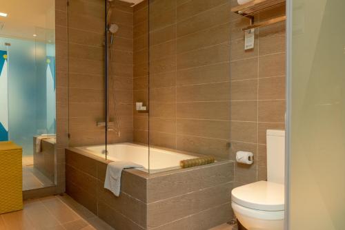 a bathroom with a shower and a toilet at Astoria Palawan in Puerto Princesa City