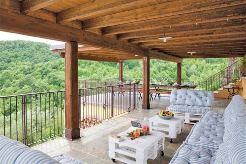 a patio with blue chairs and tables on a deck at Villa Montecastelli by Mmega in Niccone