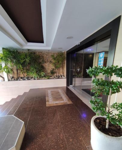 a room with a potted plant in a building at Hotel Colibrí Suites in Porlamar