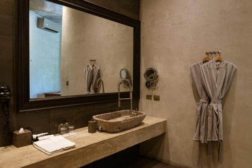 a bathroom with a sink and a mirror at Casa Malca in Tulum
