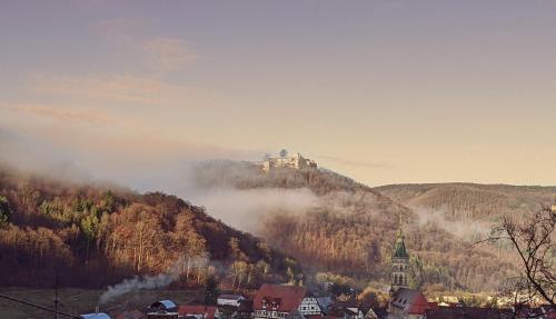 a castle on top of a hill in the mountains at Ferienwohnung in herrlicher Lage in Bad Urach