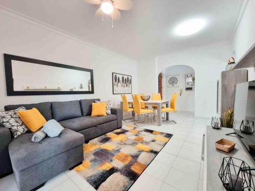 a living room with a couch and a table at Apartment Praia Rocha Candimar Sunflower in Portimão