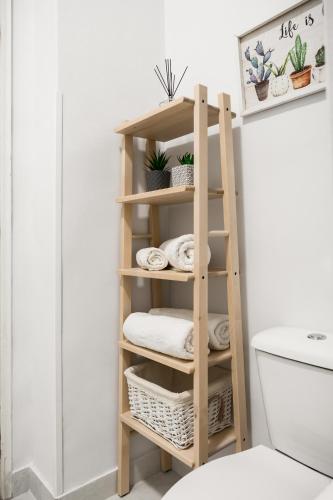 a wooden shelf in a bathroom next to a toilet at Alsos Family Apartment in Corfu