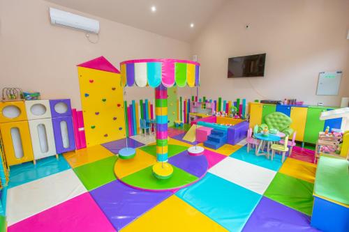 a room with a play room with a colorful floor at HARIZMA 013 in Kovin