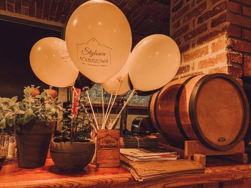 a bunch of balloons on a table next to barrels at Stylowa Kolbuszowa in Kolbuszowa