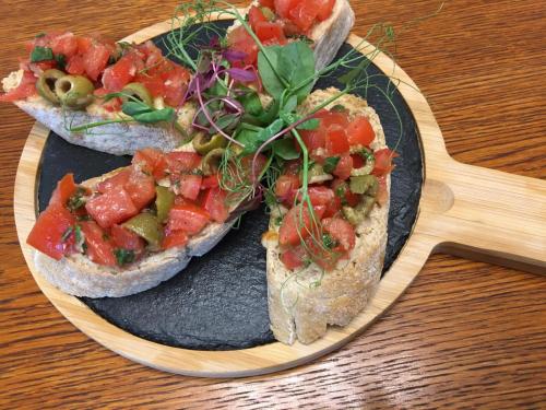 two slices of bread with tomatoes and vegetables on a plate at Stylowa Kolbuszowa in Kolbuszowa