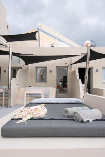a bed on a yacht with two towels on it at Caldera Cliff Illusion in Fira