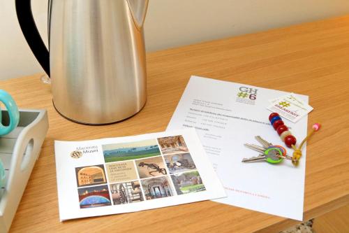 a magazine sitting on a table with scissors and pins at Guest House Viaroma in San Severino Marche