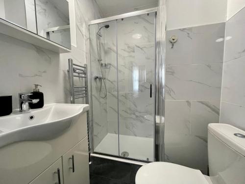 a bathroom with a shower and a sink and a toilet at Oxford Street Stays in Southampton