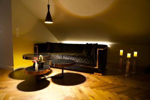 a living room with two tables and a couch at Magnifique Villa le89golden jacuzzi et sauna privatif in Mulhouse