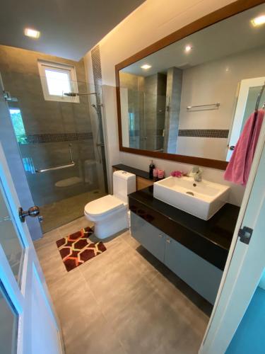 a bathroom with a sink and a toilet and a mirror at Phuket Condominium Karon beach in Karon Beach