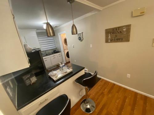 a bathroom with a vanity with two chairs and a mirror at A Modern Apt close to downtown in Lancaster