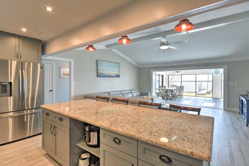 a kitchen with a counter top and a living room at Updated Waterfront Escape with Dock and Fire Pit in Pensacola