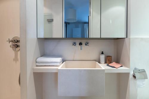 y baño con lavabo y espejo. en Luxe Atelier bail mobilité Saint germain des Près, en París