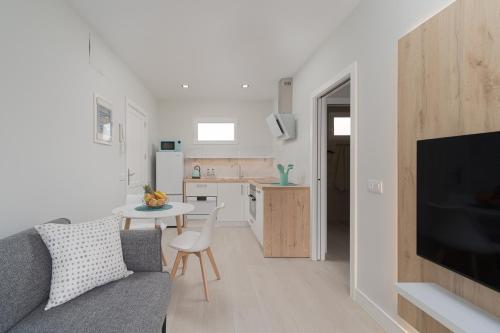 a living room with a couch and a kitchen at Melina in Arguineguín
