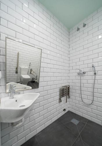 a white bathroom with a sink and a mirror at Dpaso hostel in Chantada