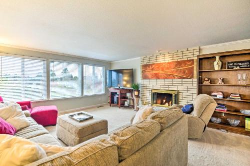 a living room with a couch and a fireplace at Spacious Tacoma Getaway 2 Mi to Old Town! in Tacoma