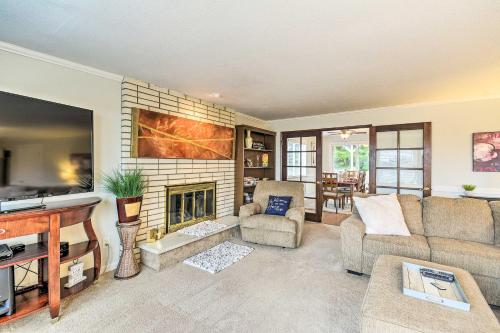 a living room with a couch and a fireplace at Spacious Tacoma Getaway 2 Mi to Old Town! in Tacoma