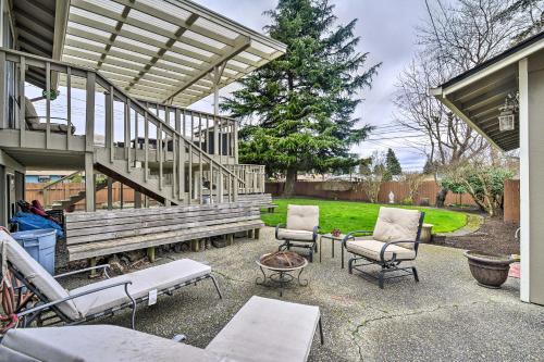 a patio with two chairs and a wooden bench at Spacious Tacoma Getaway 2 Mi to Old Town! in Tacoma