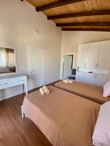 a bedroom with two beds and a desk at Tani's House in Sarandë