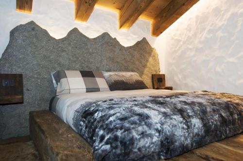 a bedroom with a large bed with a wolf headboard at AL BAIT DA LUCIA Bormio in Bormio