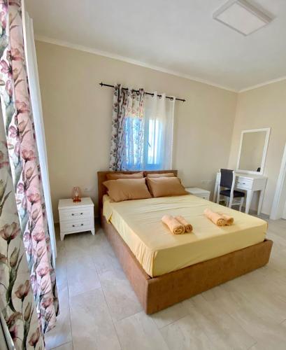 a bedroom with a bed with two towels on it at Tani's House in Sarandë