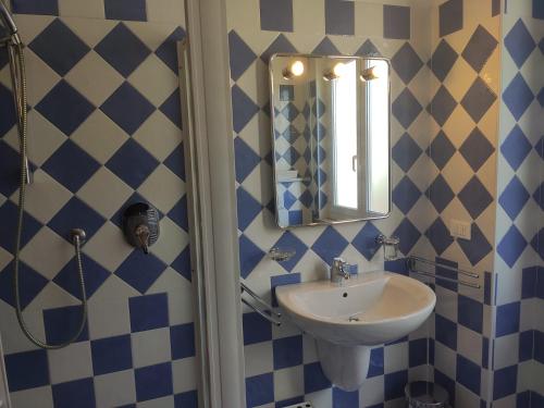 a bathroom with a sink and a mirror at Appartamenti Bemar in Diano Marina