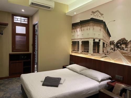 a room with a bed with a picture of a building at AM Hotel in Singapore