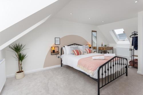 a white bedroom with a bed and a staircase at Air Host and Stay - Beautiful brand new 3 bedroom house sleeps 7 minutes from LFC - 10 in Liverpool