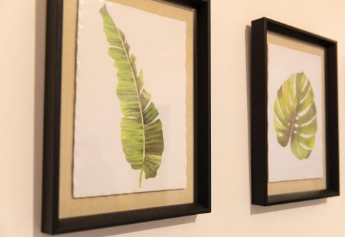two framed pictures of leaves on a wall at Fulwood Heights in Preston