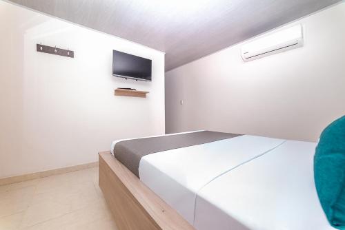 Uma cama ou camas num quarto em Ayenda Hospedaje WIV