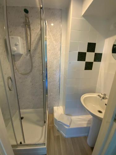 a bathroom with a shower and a sink at The Laurels Hotel in Skegness