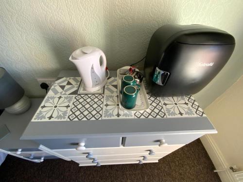 a desk with a coffee maker and a printer on it at The Laurels Hotel in Skegness