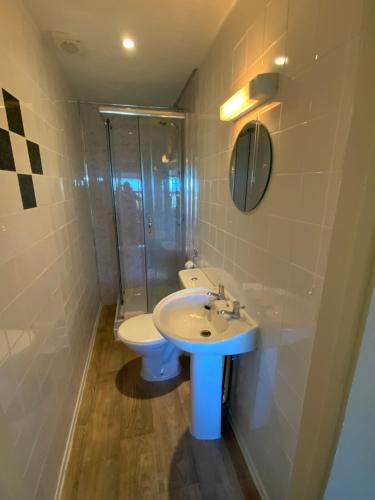 a bathroom with a sink and a toilet and a shower at The Laurels Hotel in Skegness