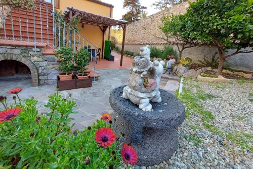 a statue of a lion sitting in a garden at B&B Villa Martina in Sardara