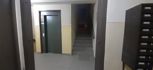 a hallway with stairs and a door in a building at Panel Hause Kazincbarcika in Kazincbarcika
